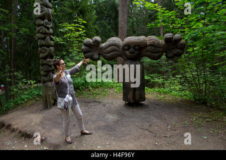 A local guide leads visitors on a tour of the Hill of Witches, site of an assemblage of more than 80 totem-like sculptures. Stock Photo