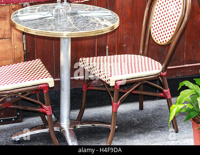 Small round table with two chairs in traditional outside café in Paris Stock Photo