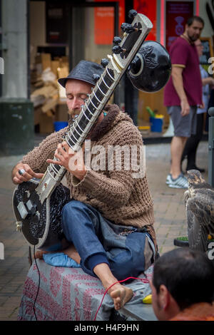 Buskers playing a Grand Pro Tun Sitar a Indian instrument in Abington Street, Northampton Town Centre. Stock Photo