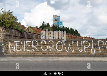 Never Grow Up! Graffiti on Commercial Street, Spitalfields, London, England, UK Stock Photo