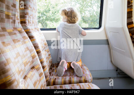 Young child of two years travelling on a London Overground train, England, UK Stock Photo