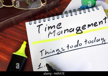Notepad with Time Management on a wooden surface. Stock Photo