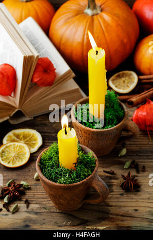 Autumn decorations: candle holder in old ceramic jug. Party decor Stock Photo