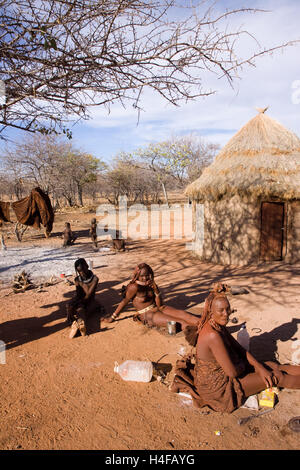 himba women with their children in a camp in north namibia Stock Photo