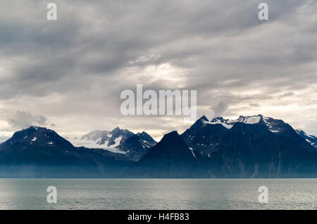 Dark clouds over mountains by Lyngenfjord, Norway Stock Photo