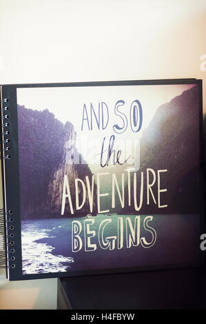 Photograph of a book with title and so the adventure begins Stock Photo