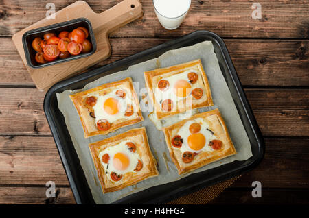 Tomato, Egg, and Prosciutto Tart from puff pastry, baked in oven Stock Photo