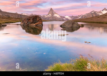 Sunrise on the shores of Stellisee Lake in front of Matterhorn, Zermatt, Switzerland. Stock Photo