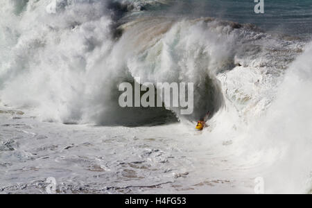 Body surfing in extreme conditions at Waimea Bay on the north shore of Oahu Hawaii USA Stock Photo