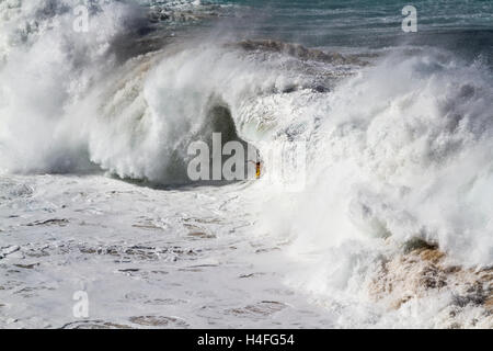 Body surfing in extreme conditions at Waimea Bay on the north shore of Oahu Hawaii USA Stock Photo