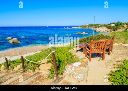 Wooden teak chairs and tables on Cala Caterina beach, Sardinia island, Italy Stock Photo