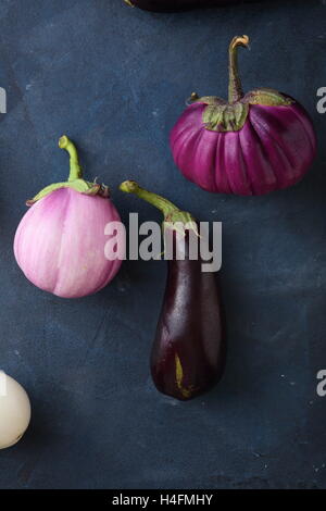 Organic eggplants on stone background, food above Stock Photo