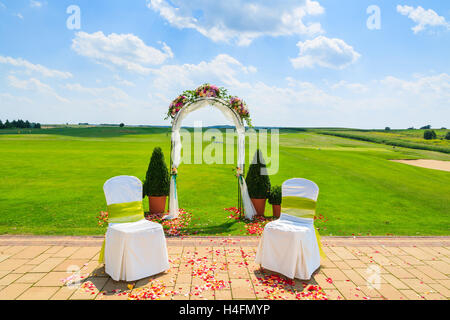 Arch and two white chairs in golf club prepared for weeding ceremony, Poland Stock Photo