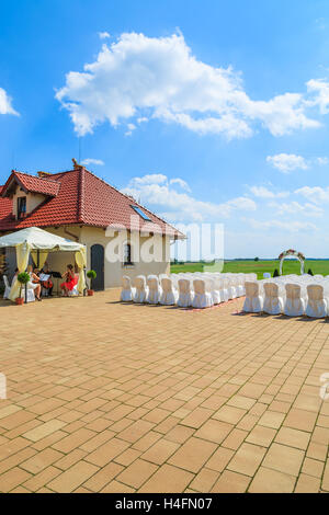 PACZULTOWICE GOLF CLUB, POLAND - AUG 9, 2014: orchestra plays music and prepares for weeding ceremony in a golf club with white chairs setup, Poland. Stock Photo