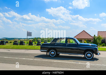 PACZULTOWICE GOLF CLUB, POLAND - AUG 9, 2014: old classic black car parks on street in Paczultowice Golf Club. Vintage cars are popular to drive people to weeding ceremony. Stock Photo