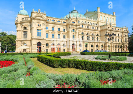 Green park in front of Slowackiego Theater building in Krakow, Poland Stock Photo