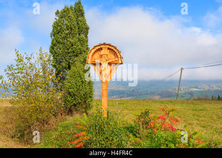 Typical small chapel on side of a road in autumn landscape of Beskid Niski Mountains, Poland Stock Photo