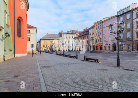 KRAKOW, POLAND - DEC 10, 2014: colourful houses on square in Krakow. Many tourists visit Krakow which is most popular destination in Poland. Stock Photo