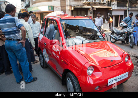 Red eco environmentally friendly small,micro,Reva smart mini,micro,car ,in street near Indian Stock Market,Mumbai,Maharashtra,India,Asia. Stock Photo