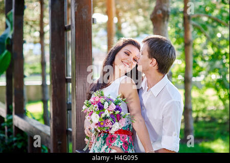 young couple walking and hugging in the park Stock Photo