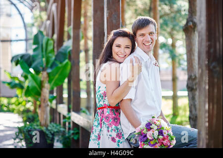 young couple walking and hugging in the park Stock Photo