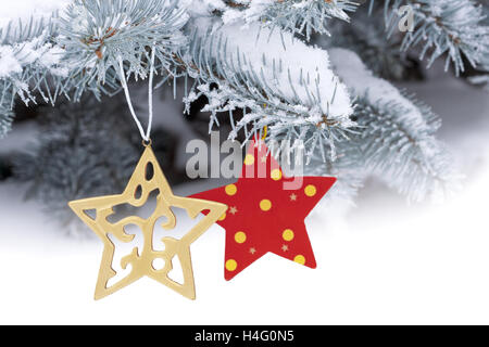 Christmas ornament on snow-covered tree Stock Photo