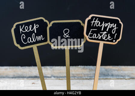 Keep Calm and Happy Easter message written with chalk on mini blackboard labels Stock Photo