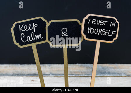 Keep Calm and Trust In Yourself message written with chalk on mini blackboard labels Stock Photo