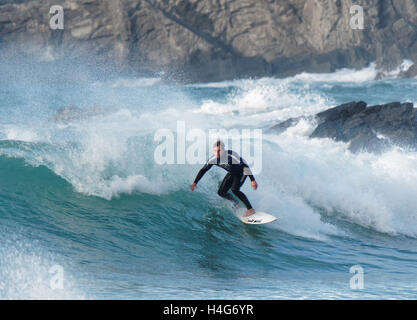 Student surfing contestants compete in large sunlit waves at Fistral beach Newquay, Cornwall. Stock Photo