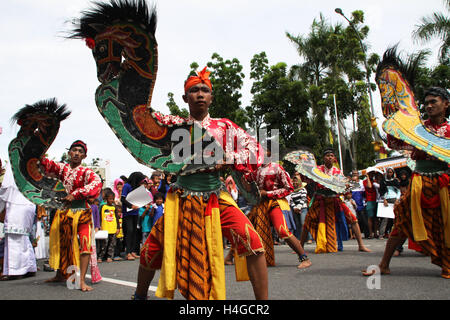 October 16, 2016 - Pekanbaru, Riau, Indonesia - RIAU, INDONESIA - OCTOBER 16 : Indonesia people dance with horse replica called Kuda Lumping at Pekanbaru on October 16, 2016 in Riau, Indonesia. Kuda Lumping is a traditional Javanese dance depicting a group of horsemen. Dancers ''ride'' horses made from woven bamboo and decorated with colorful paints and cloth. Generally, the dance portrays troops riding horses, but another type of Kuda Lumping performance also incorporates trances and magic tricks. When the ''possessed'' dancer is performing the dance in trance conditions, he can display unusu Stock Photo