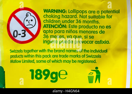 Warning lollipops are a potential choking hazard not suitable for children under 36 months - information on pack of Swizzels loadsa sweets Stock Photo