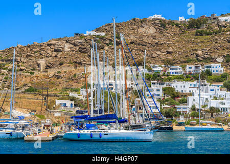 MYKONOS ISLAND, GREECE - MAY 17, 2016: Sailing boats in Mykonos new port, Cyclades islands, Greece. Stock Photo