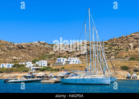 MYKONOS ISLAND, GREECE - MAY 17, 2016: Sailing boats in Mykonos new port, Cyclades islands, Greece. Stock Photo