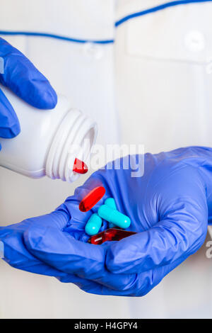 Doctor pouring pills on hand. Medical healthcare concept in hospital. Stock Photo