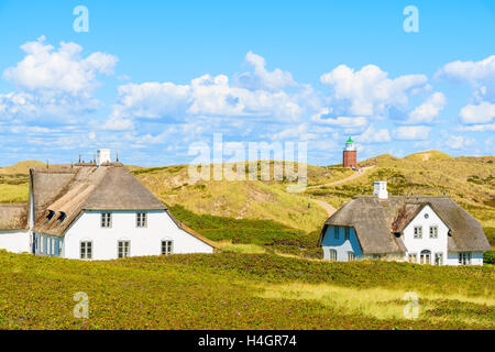 Typical Frisian houses with straw roofs on sand dunes in Kampen village, Sylt island, Germany Stock Photo
