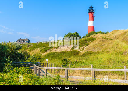 Lighthouse on sand dune against blue sky in Hornum village on southern coast of Sylt island, Germany