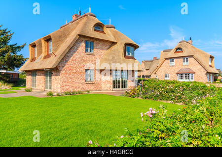 Typical Frisian red brick houses with straw roofs in Rantum village on southern coast of Sylt island, Germany Stock Photo