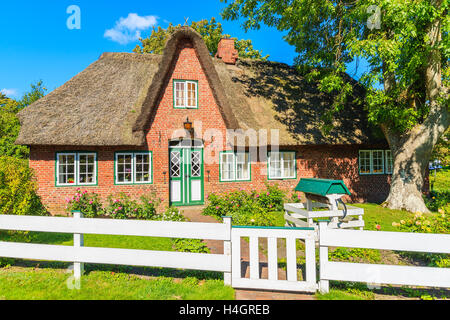 Traditional red brick house with thatched roof in Keitum village on Sylt island, Germany Stock Photo