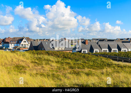 View of typical houses in Wenningsted village with grass sand dune in foreground on Sylt island, Germany Stock Photo