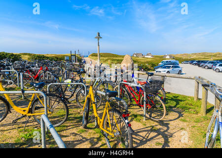 SYLT ISLAND, GERMANY - SEP 11, 2016: Bikes parked near beach entrance on coastal path in Kampen village on western coast of Sylt Stock Photo