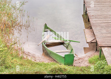 Abandoned boat on a lake shore Stock Photo