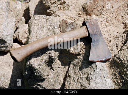 Old used resting Axe on a grey stone background Stock Photo