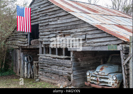 Vintage barn with old Chevy truck and new American flag in Lawrenceville, Georgia. (USA) Stock Photo