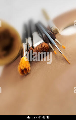 Different Paint Brushes on Palette Perspective view set of different brushes on a palette Stock Photo