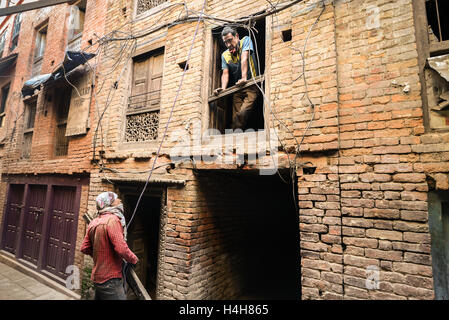Construction workers talk to each others in old town of Bhaktapur, Nepal. Stock Photo