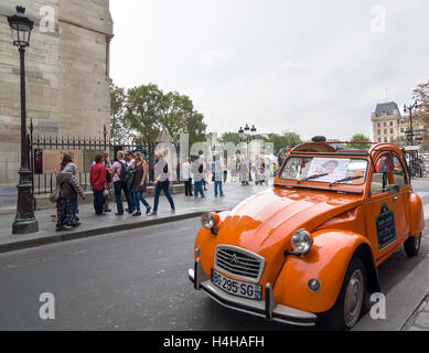 PARIS - SEPT 17, 2014: Old Citroen 2CV parked at cathedral Notre-Dame de Paris, Paris, France. Stock Photo