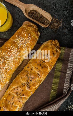 Roll out puff pastry stuffed with mushrooms, cheese and ham Stock Photo