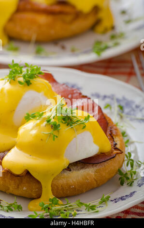 Eggs benedict, prosciutto topped with Hollandaise sauce Stock Photo