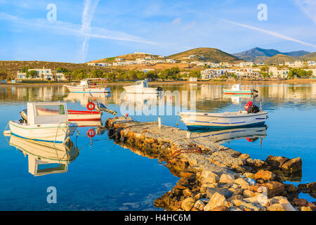 Fishing boats mooring in Naoussa port at sunrise time, Paros island, Cyclades, Greece Stock Photo