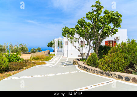 A typical white house in green rural landscape of Imerovigli village on Santorini island, Greece Stock Photo